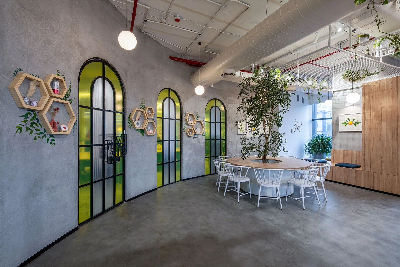 A modern office featuring a circular table surrounded by several chairs, promoting collaboration and discussion.