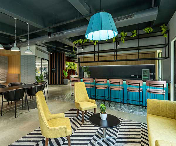 Odessa Thumbnail: An office featuring vibrant yellow chairs and a stylish black and white rug